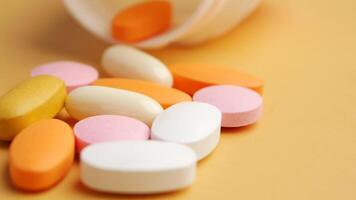 An Array of Assorted Vitamins and Medications Displayed on a Bright Yellow Surface video