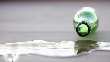 A Green Bottle filled with Water has been accidentally Spilled on the Floor, creating a mess video