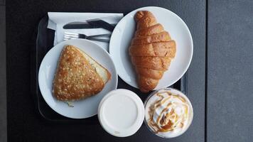 Enjoy a tasty breakfast with a flaky croissant and your choice of creamy beverage video