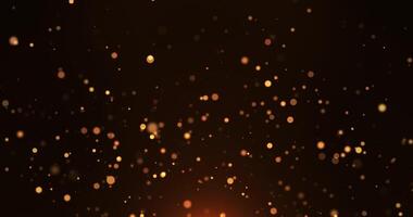Abstract animation concept of golden particles for celebrating birthdays and holidays. 4k loop bokeh background with light particles on a dark background. Animation footage video