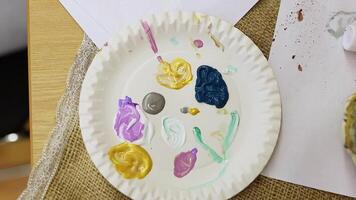 painting masterclass showcases a table filled with a palette of bright paints, inviting artists to unleash their creativity as they transform ordinary pumpkins into unique masterpieces. video