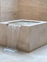 modern water feature with flowing waterfall photo