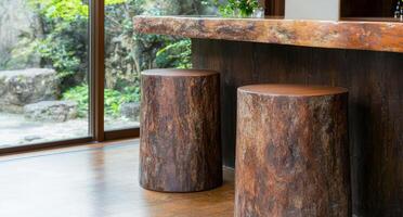 Rustic wooden stools in a modern interior with nature view photo