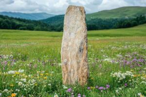 Majestic stone monolith in a lush meadow photo