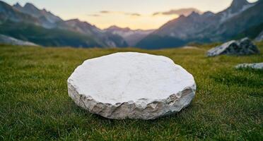Serene mountain landscape with large rock in foreground photo