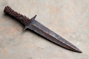 Rugged metal knife with spiked handle photo