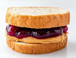 Peanut butter and jelly sandwich on white background photo