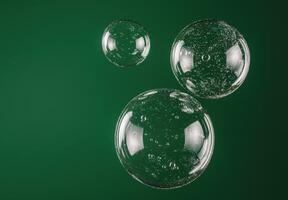 Transparent bubbles floating on green background photo