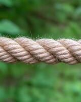 Close up of a twisted rope against a blurred green background photo