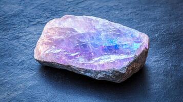 Stunning iridescent amethyst crystal on dark background photo