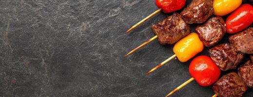 Grilled meat and vegetables on skewers photo