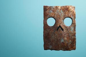 Rusty metal mask with eye holes on teal background photo