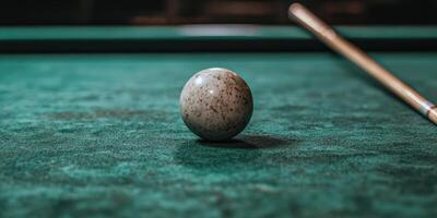 A billiard ball sits on a pool table photo