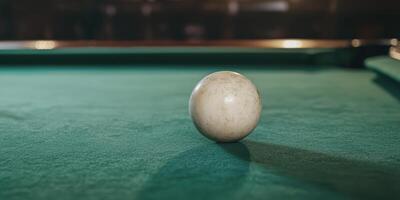 A white egg sitting on top of a pool table photo