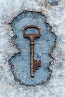 Rusty old key in ice photo