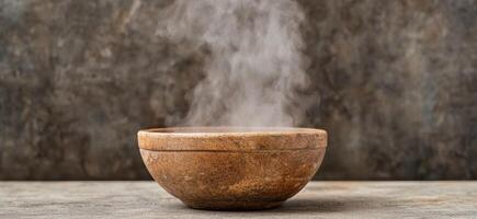 Steaming bowl of soup or stew on wooden table photo