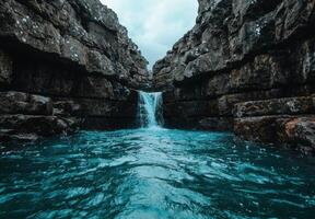 Stunning waterfall cascading into a turquoise pool photo