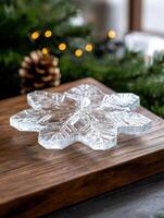Sparkling snowflake ornament on wooden table with christmas lights photo