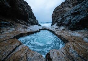 Dramatic rocky coastline with crashing waves photo