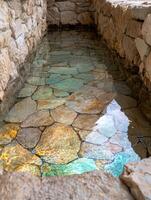Vibrant natural pool in rocky cave photo
