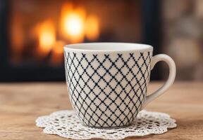 cozy mug with patterned design on wooden table photo
