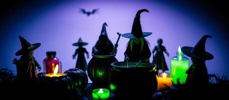 miniature witches stir a cauldron a halloween setting photo