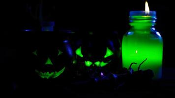 three glowing green objects on a dark surface photo