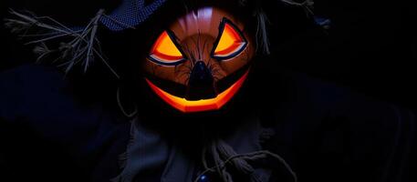 luminous carved pumpkin face with a straw hat photo