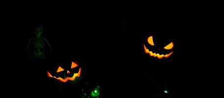 illuminated jack-o'-lanterns a skeleton cast a spooky glow photo