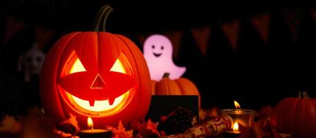 smiling jack-o'-lantern illuminates a festive halloween table photo