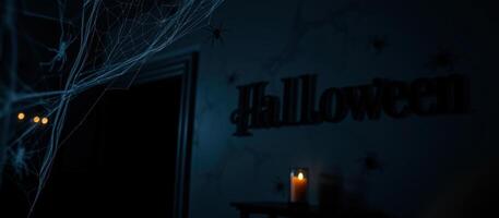 spider web with a single light source casts a faint glow on a halloween decoration. photo