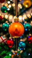 shiny ornament hangs from a decorated christmas tree photo