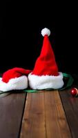 red white santa hats on a wooden surface photo