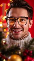 man with a warm smile gazes at the camera while standing near a festive backdrop. photo