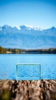 clear glass box resting on a wooden dock with a scenic water view photo