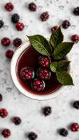 red berries a bowl with a green leaf photo