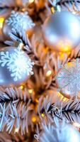 close- a white christmas tree with shiny snowflake ornaments warm lights photo