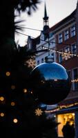 reflective ornament decorated with a snowflake hangs the city photo