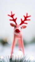 pink reindeer figurine with red antlers stands a festive setting photo
