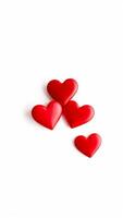 four red hearts on a white background photo