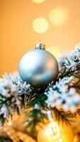 single blue bauble hangs from a christmas tree branch photo