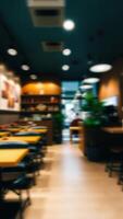 blurred view a dining area with yellow tables black chairs photo