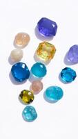 faceted glass gems scattered on a white background photo