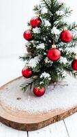 small evergreen tree decorated with red ornaments faux snow photo