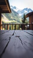 weathered wooden table with a mountain view photo