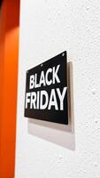 black friday sign mounted on a textured white wall photo