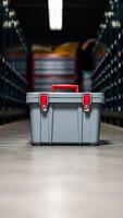 gray storage container with a red handle photo