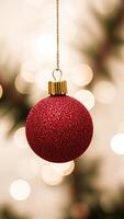 red sparkly ornament hanging from a string photo