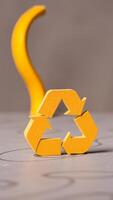 yellow cardboard recycling symbol on a gray surface photo