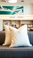 two white throw pillows on a gray sofa photo